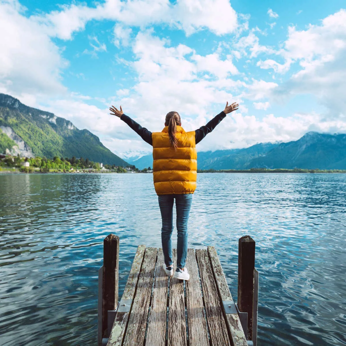 A solo female traveler by a lake in Switzerland