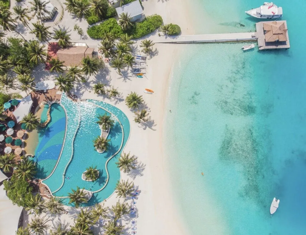 Aerial view of a all-inclusve resort pool overlooking the ocean in Barbados