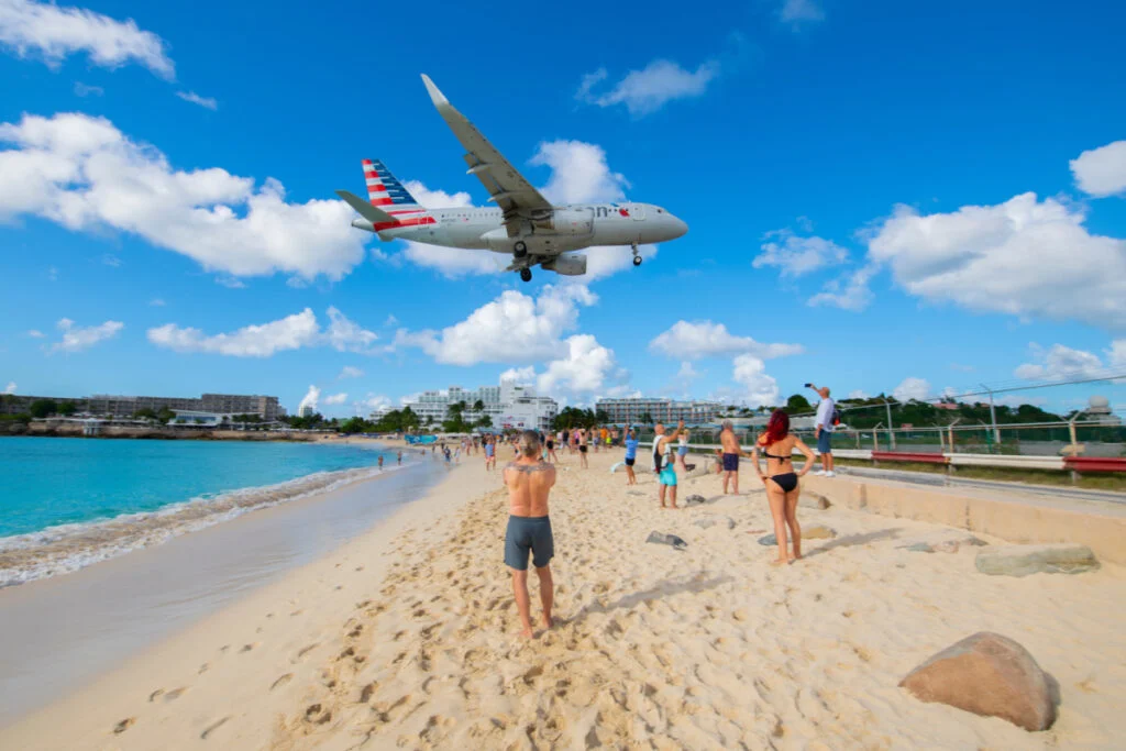 American Airlines plane flying over St. Maarten beach to land at aiport