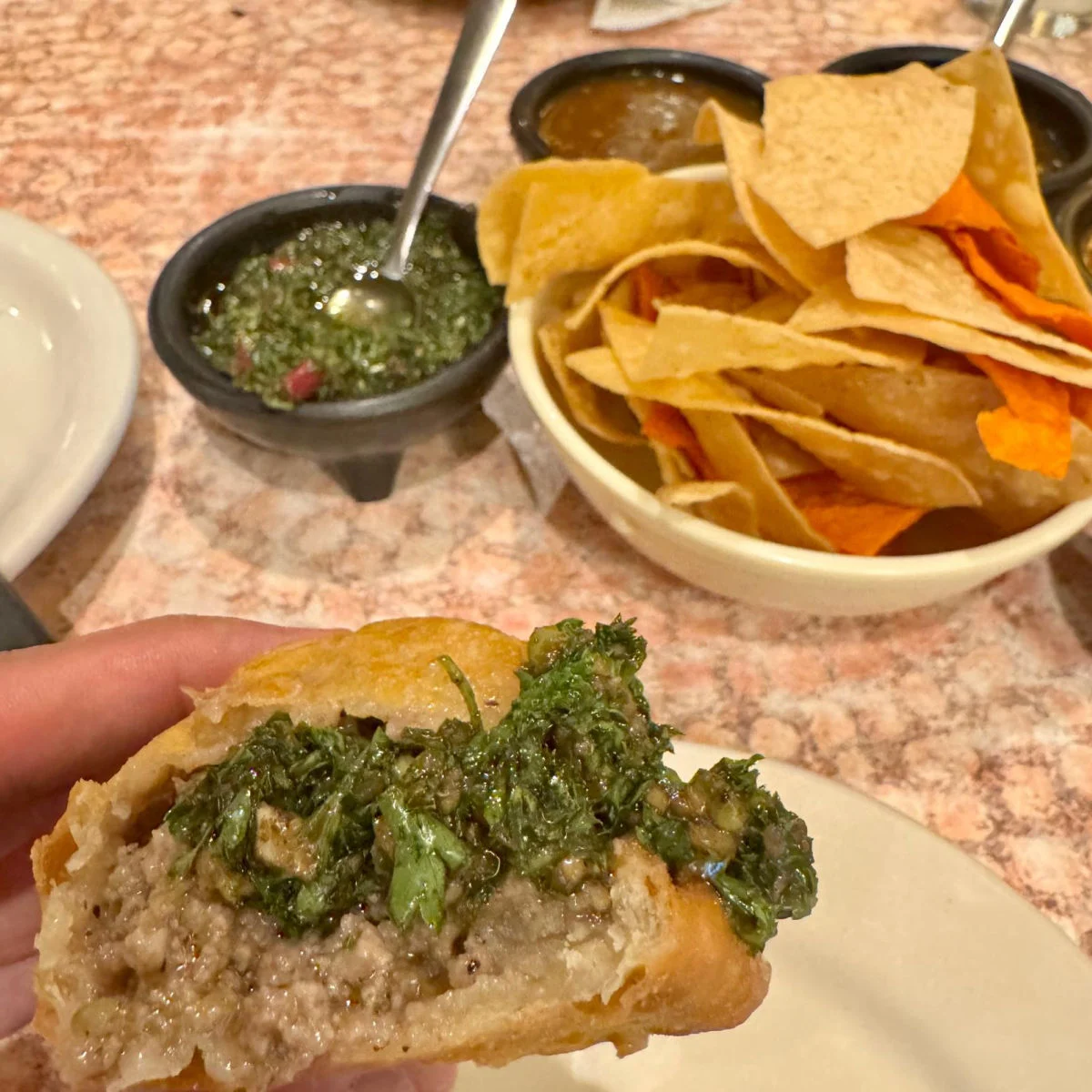 Chimichurri slathered on empanada at Los Barrios - San Antonio, Texas