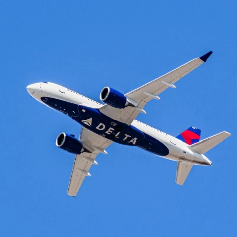 Delta Airlines aircraft in flight; the Delta Logo visible on the airplanes' underbelly
