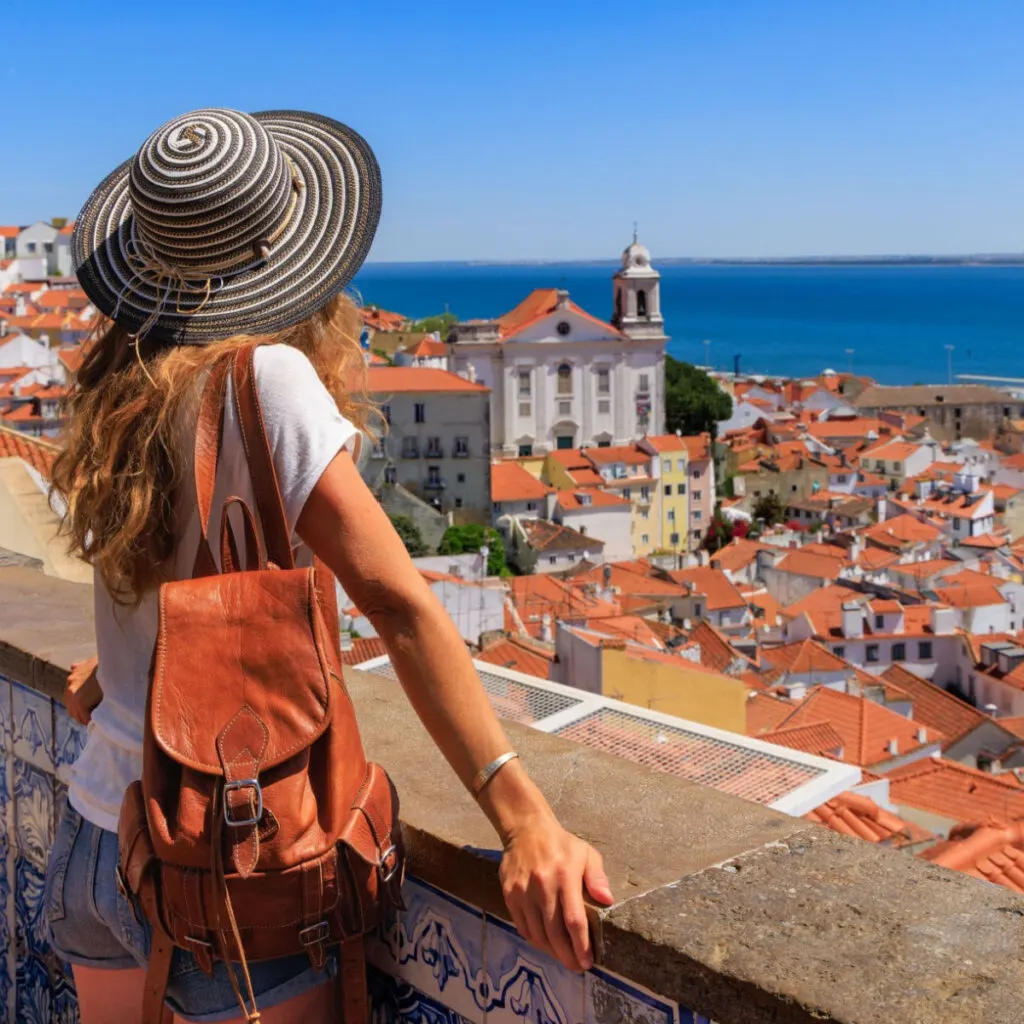 Female traveler looking down at Lisbon, Portugal