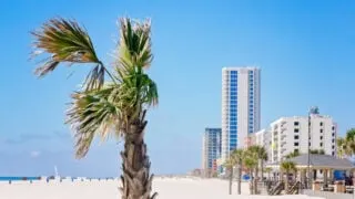 Towering condos on white sand beach in Gulf Shores