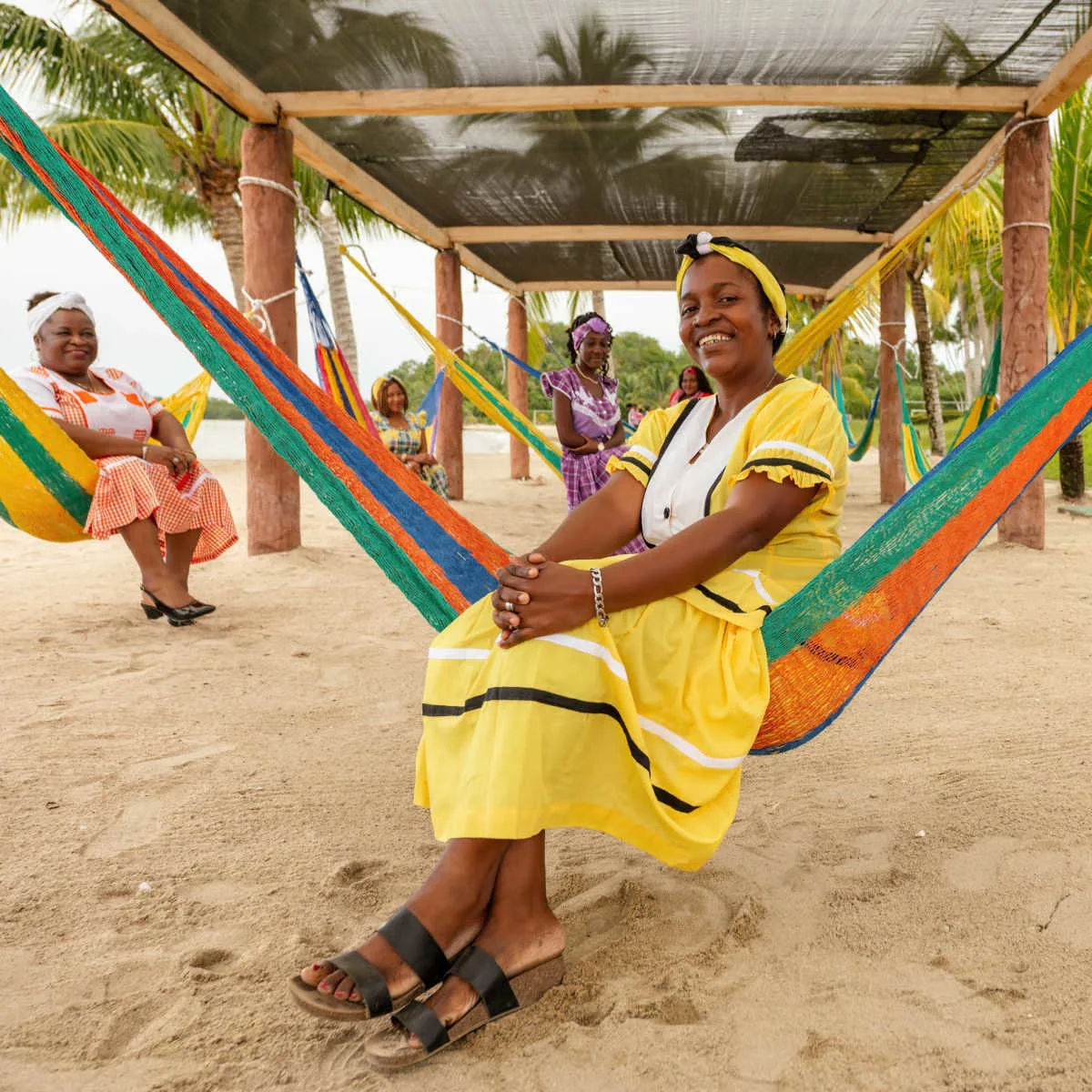 Garifuna women on beach hammocks in Livingston, Guatemala
