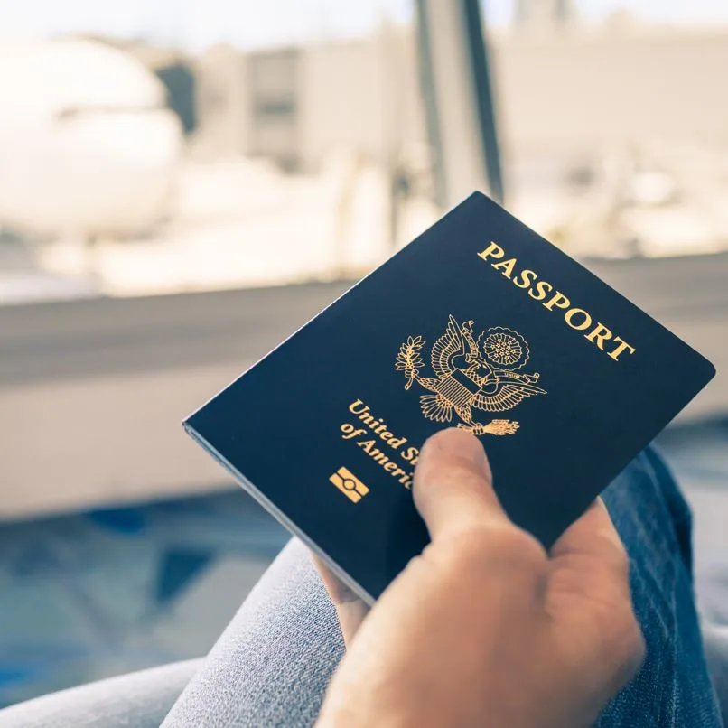 holding a passport at the airport