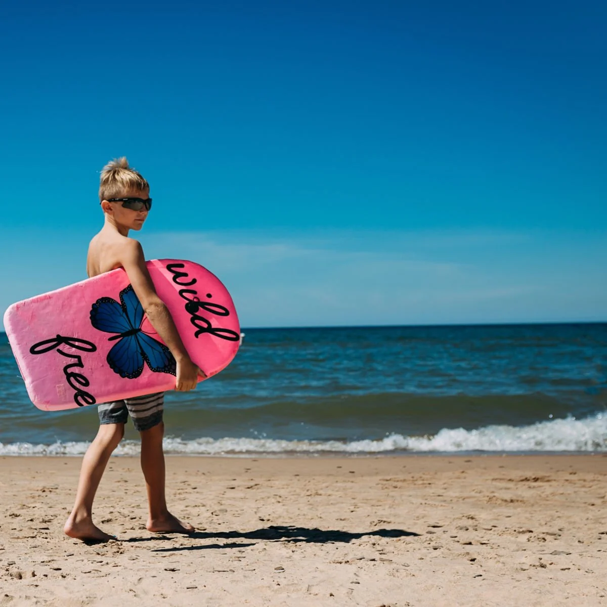 Kid with boogie board at Indiana Dunes beach 