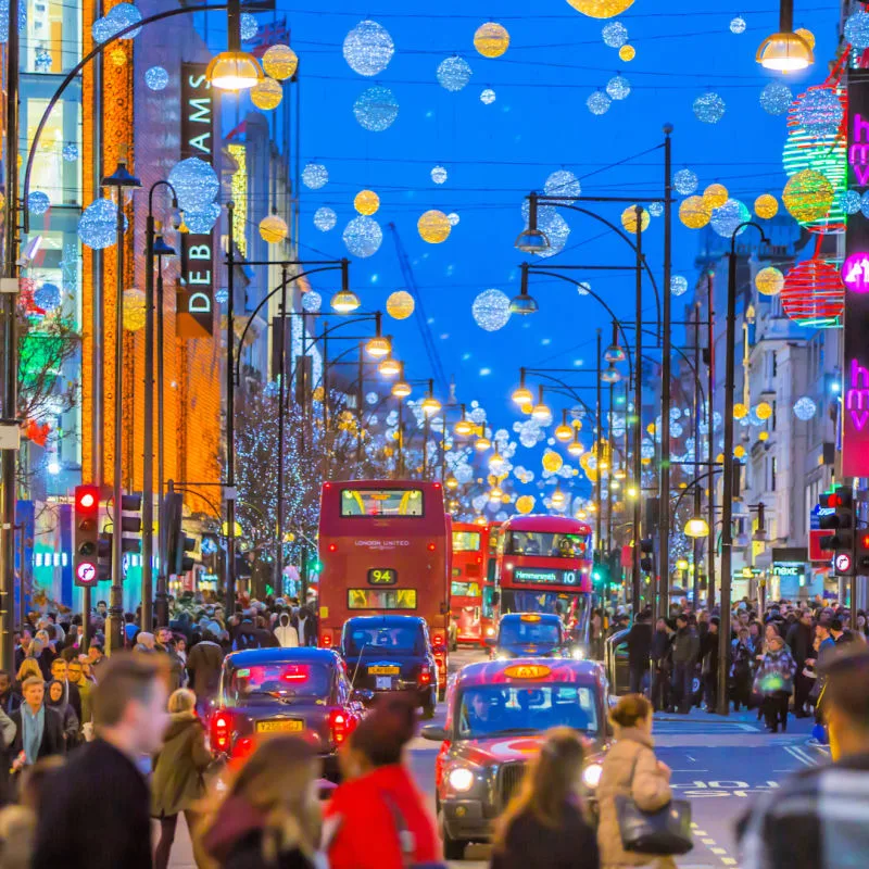 LONDON, UK - Christmas lights decoration at Oxford street and lots of people walking during the Christmas sale, public transport, buses and taxis