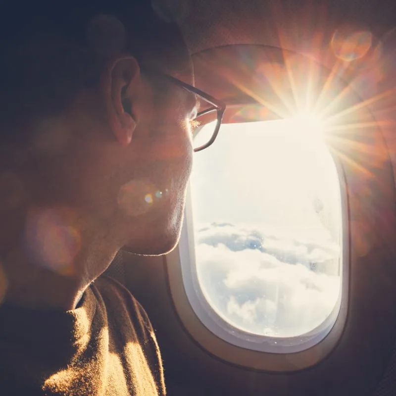 Man looking out airplane window