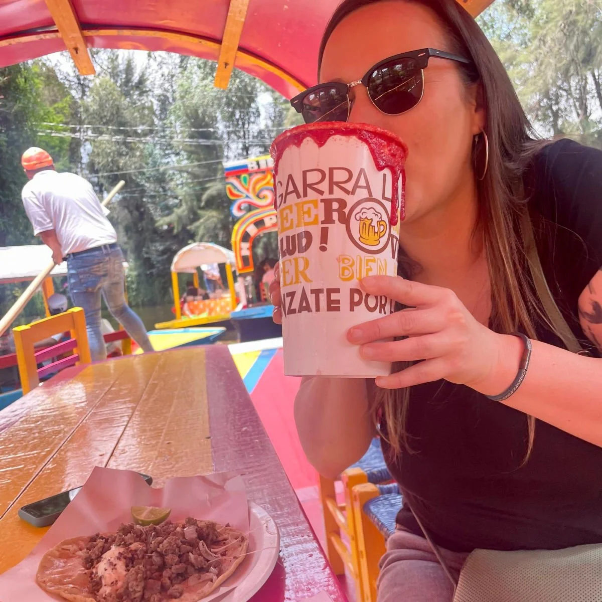 Michelada and taco on boat ride in Xochimilco near Mexico City