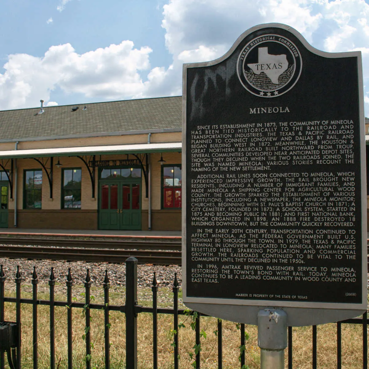 Mineola, TX sign at train station