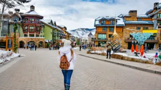 Woman walking through Vail in winter