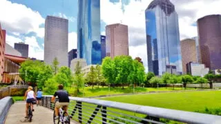 Couple riding bike near downtown Houston, TX
