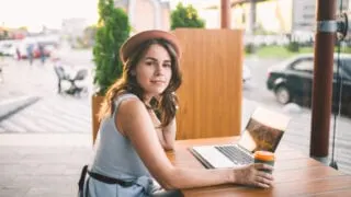 Female digital nomad with coffee at France cafe