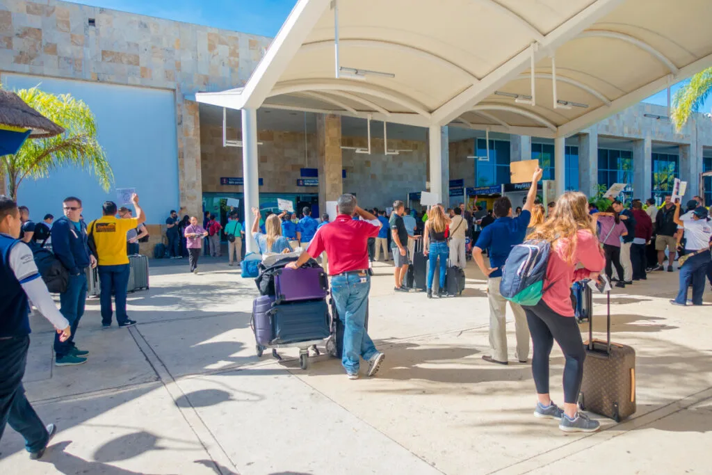 Travelers waiting for rides outside Cancun airport