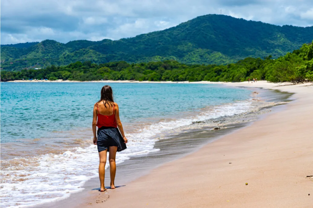 Young woman taking walk on beach in Costa Rica