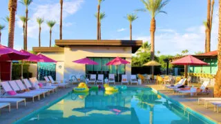 Palm trees and lounge chairs at resort pool in Palm Springs, CA