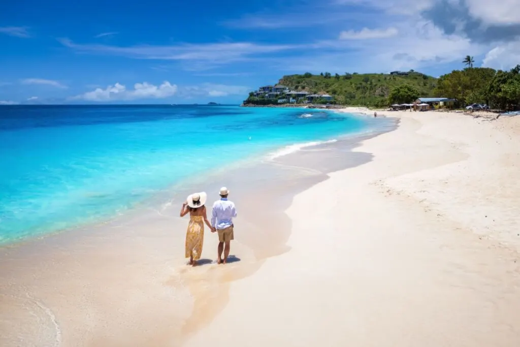 Couple walking on a beach in Antigua and Barbuda