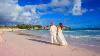 Couple walking on horseshoe bay beach, Bermuda