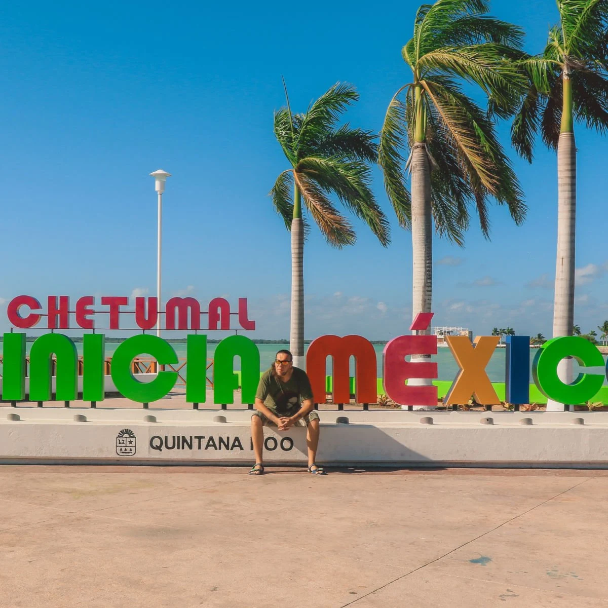 Tourist posing at colorful Chetumal sign