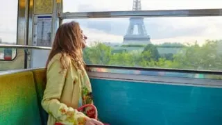 Woman passing Eiffel Tower on train