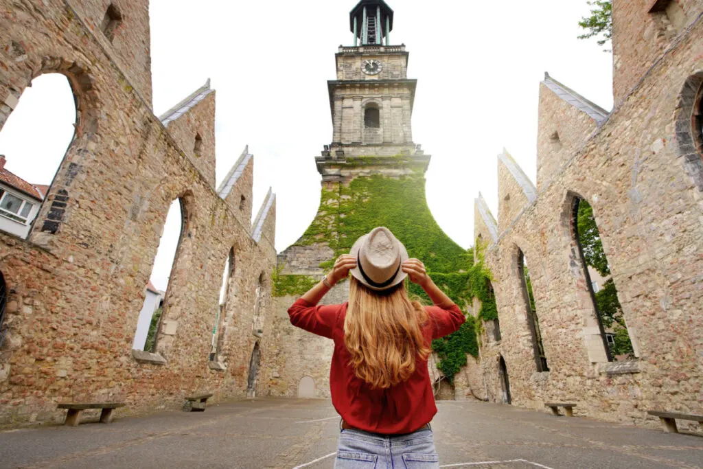 Woman visiting historic church in Hanover, Germany