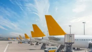 Row of passenger plane tails on the runway