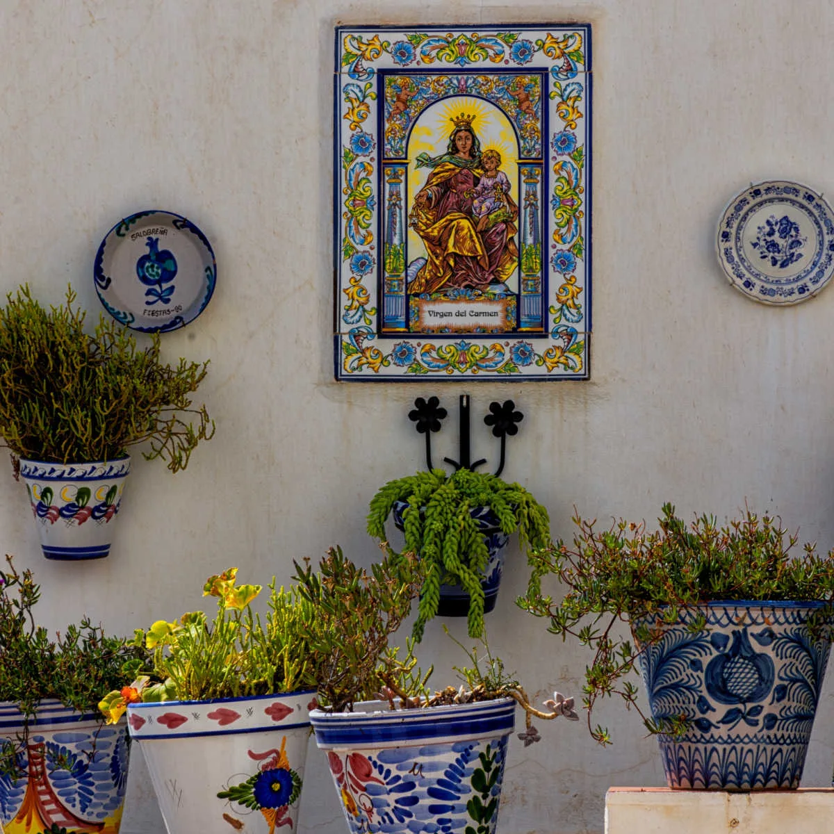 Wall decor and flower pots in Old Town Salobre&ntilde;a, Spain