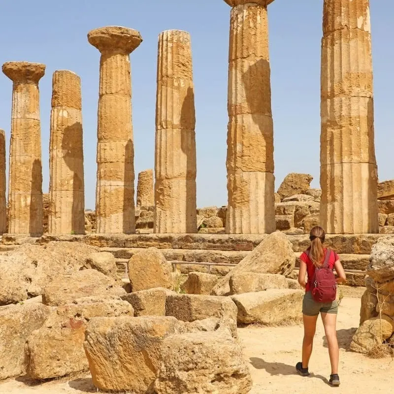Young Woman Exploring The Valley Of The Temples In Agrigento, Sicily, Italy